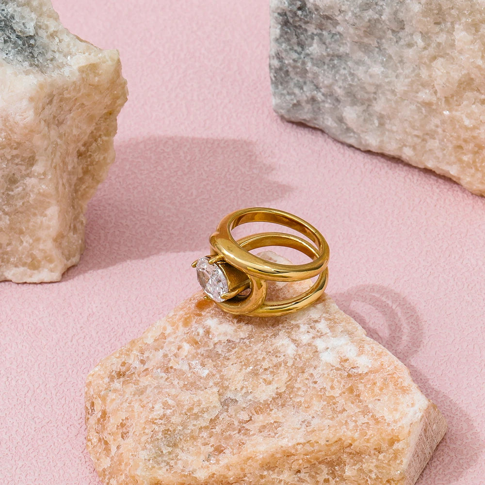 Rustic Charm: Gold-Tone Twisted Band with Oval-Cut Crystal